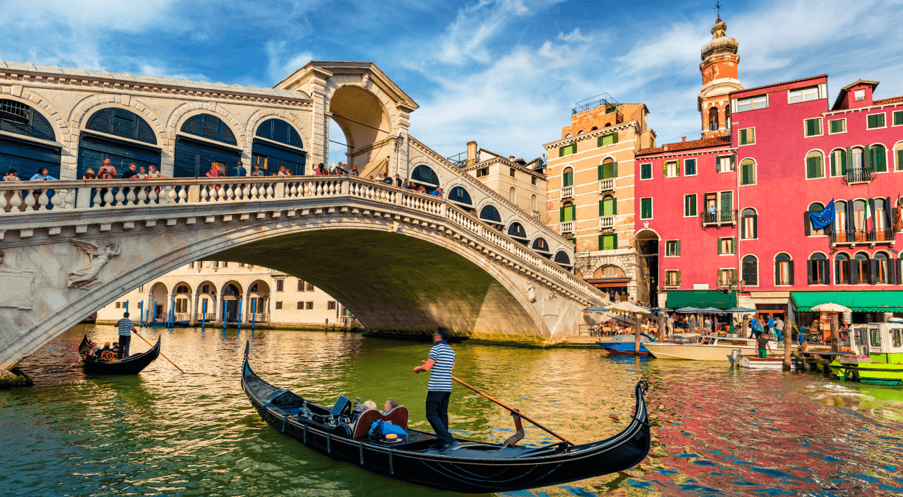 Gondolas glide effortlessly beneath arched bridges